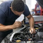 Gnv estourando o que pode ser: mecânico confere a ignição de um carro com GNV estourando ao acelerar numa oficina